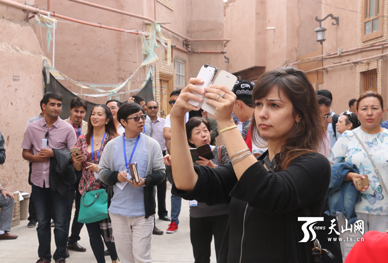 “丝绸之路经济带相关国家媒体负责人研修班”学员走进喀什老城区，摄像机、相机、手机齐上阵。